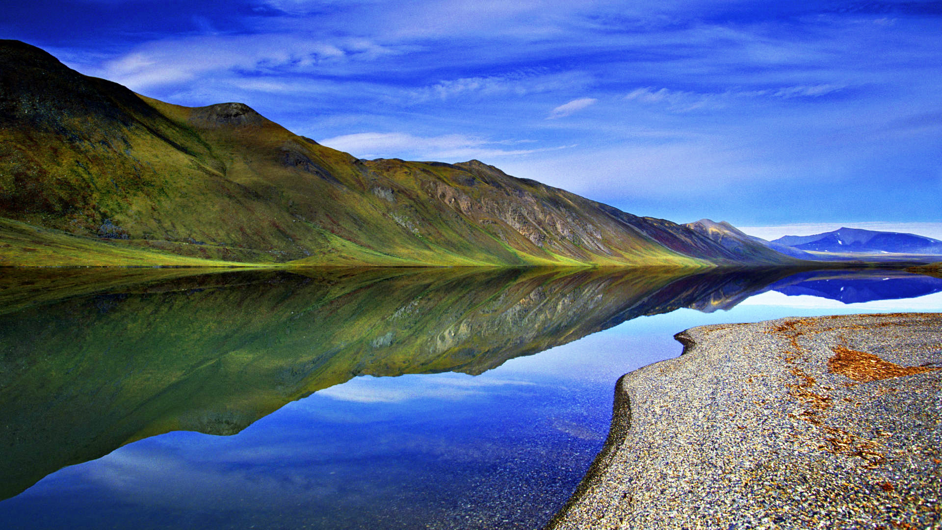 An extremely rare, calm day brings almost perfect reflections to the surface of Lake Peters in Alaska's Arctic National Wildlife Refuge.
